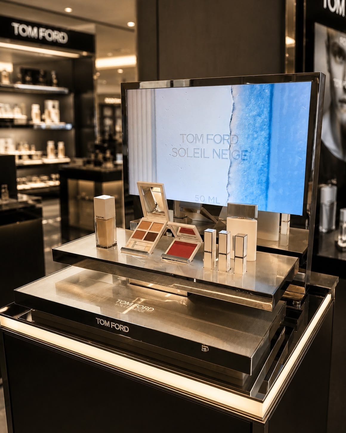 arX Display Tom Ford Soleil Neige countertop display with an integrated video screen and tiered trays showcasing cosmetics and fragrance