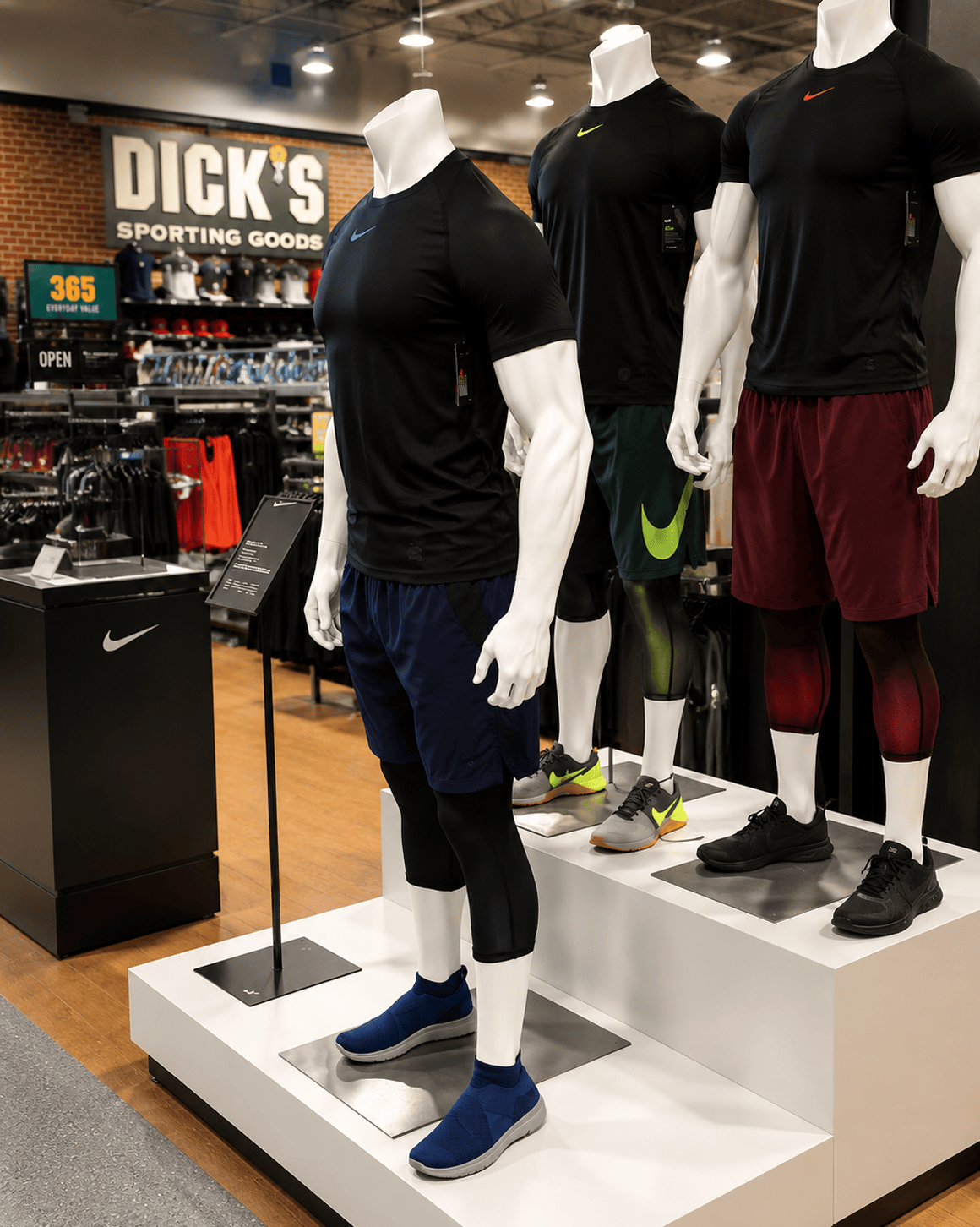 arX Display specialty retail apparel display with athletic mannequins on platforms inside a Dicks Sporting Goods store